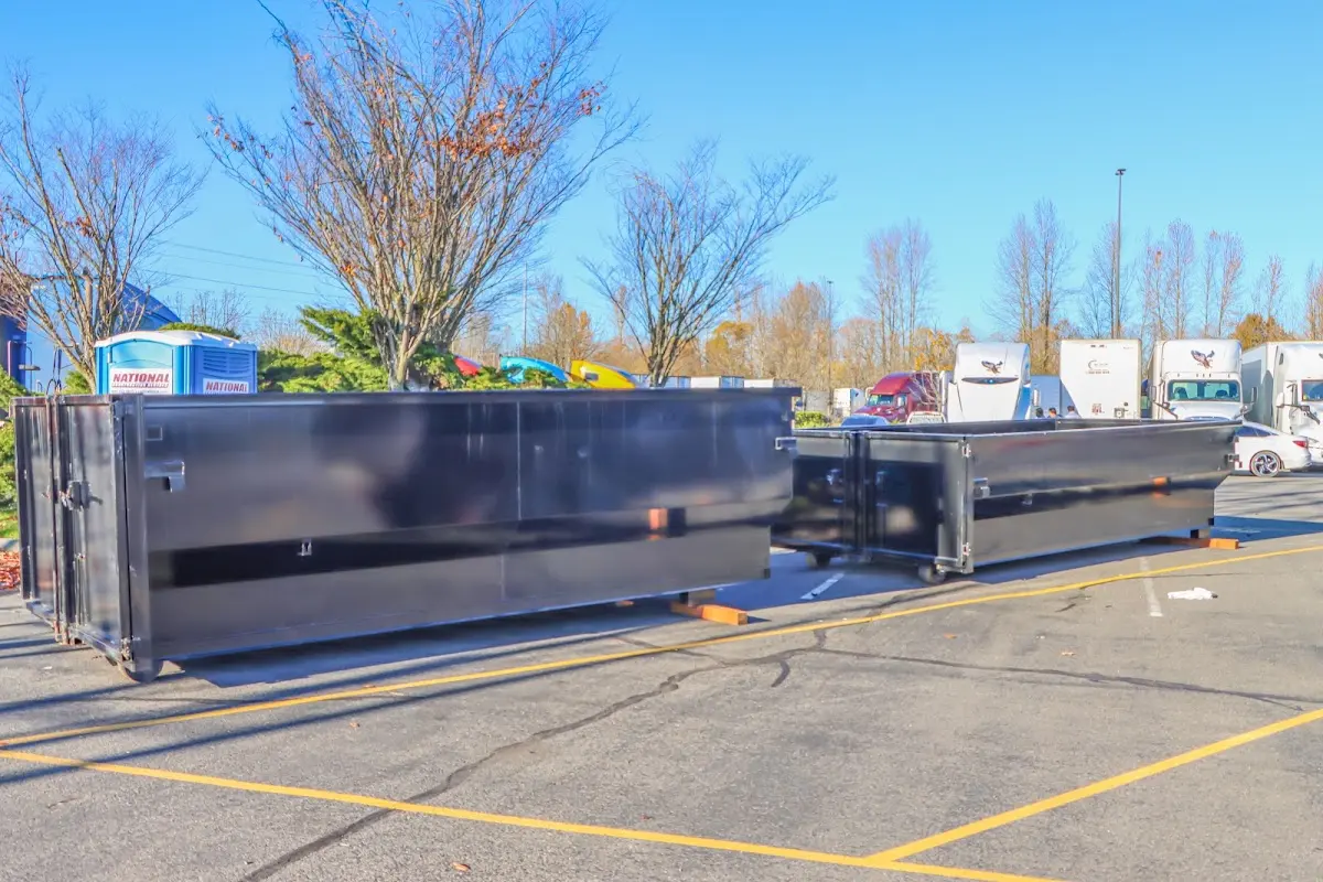 Professional dumpster rental service with roll-off container on residential driveway in Paducah